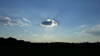 a single sun-obscuring cloud over a field in the stinderbrook valley